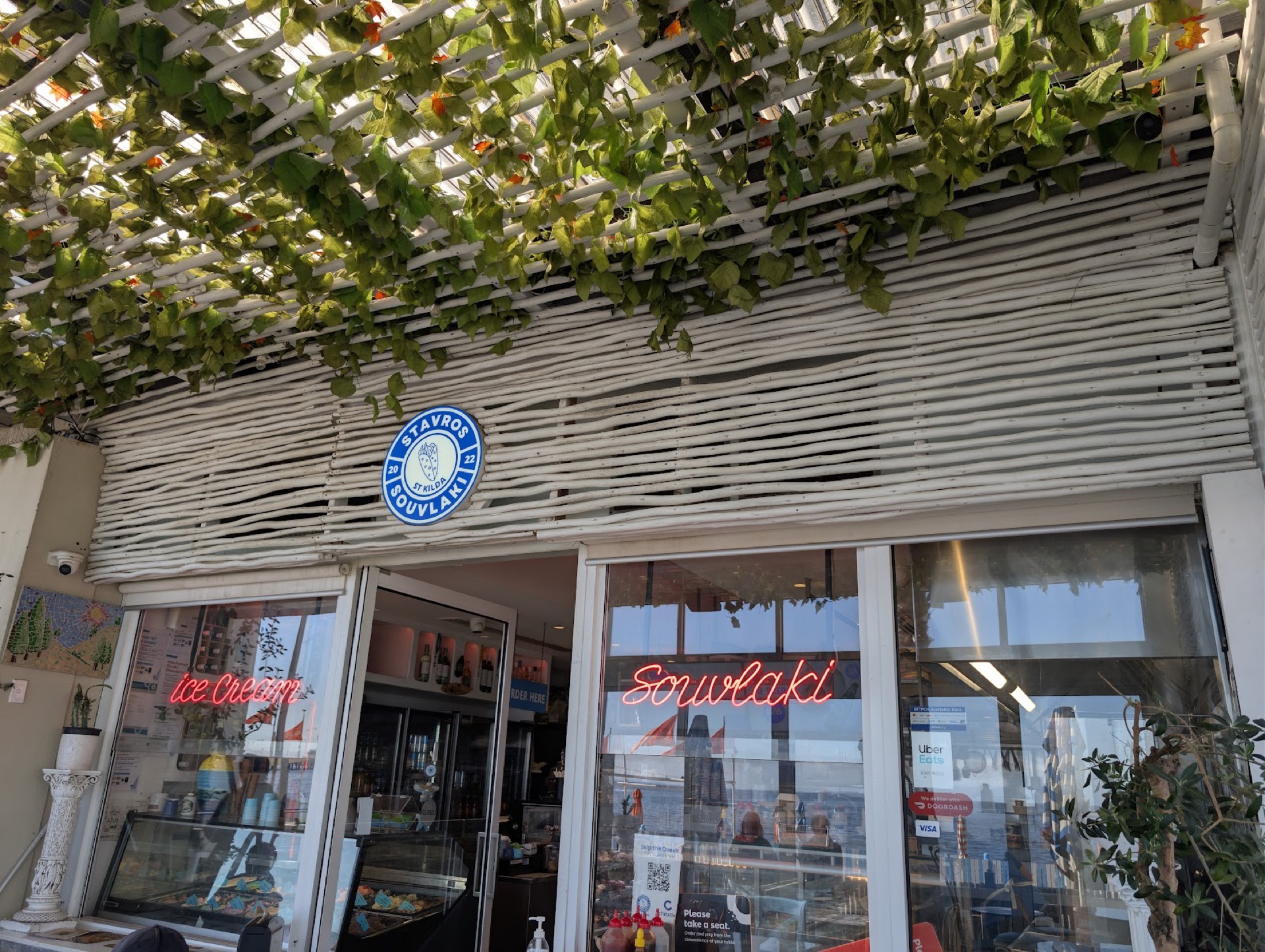 Stavros Souvlaki shopfront with neon souvlaki and ice cream signs